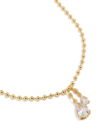 Showcasing double teardrop cubic zirconia pendant on gold plated ball chain necklace close up view - link has visual effect only