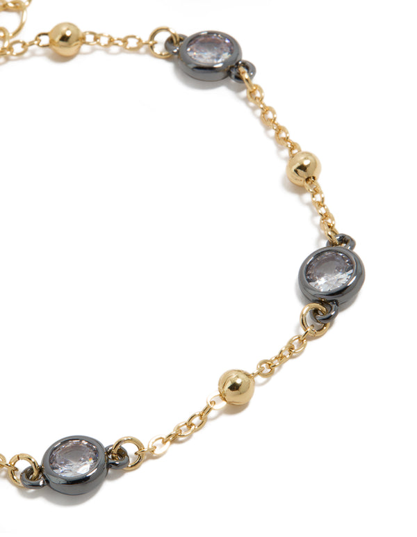 This mixed metal bracelet with cubic zirconia stones and ball chain design crafted from gold plated materials close up view