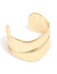 Showcasing a gold plated wide organic wrist cuff with statement bangle design front view - link has visual effect only