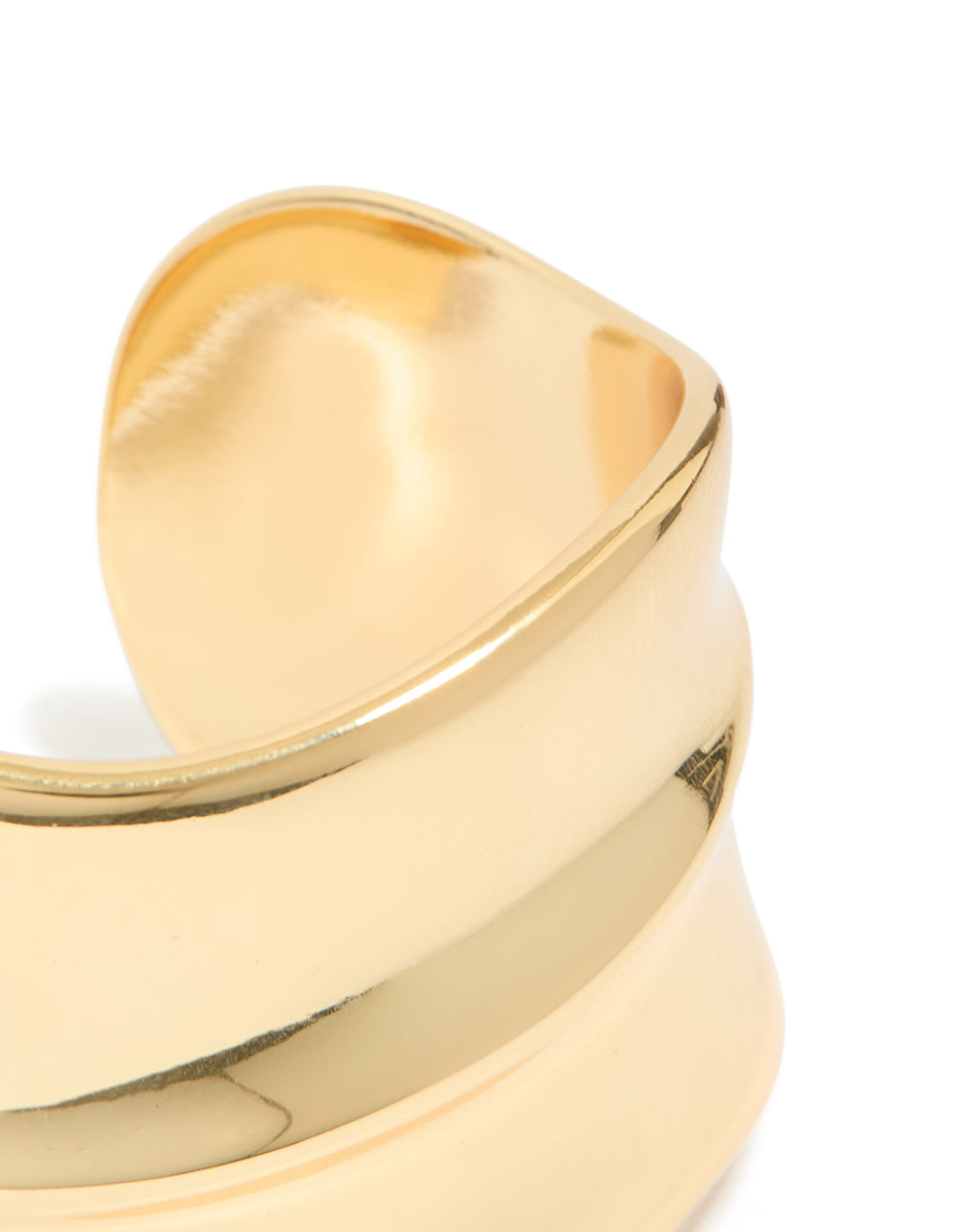 Designed with gold plated wide organic wrist cuff in statement bangle style closure detail view