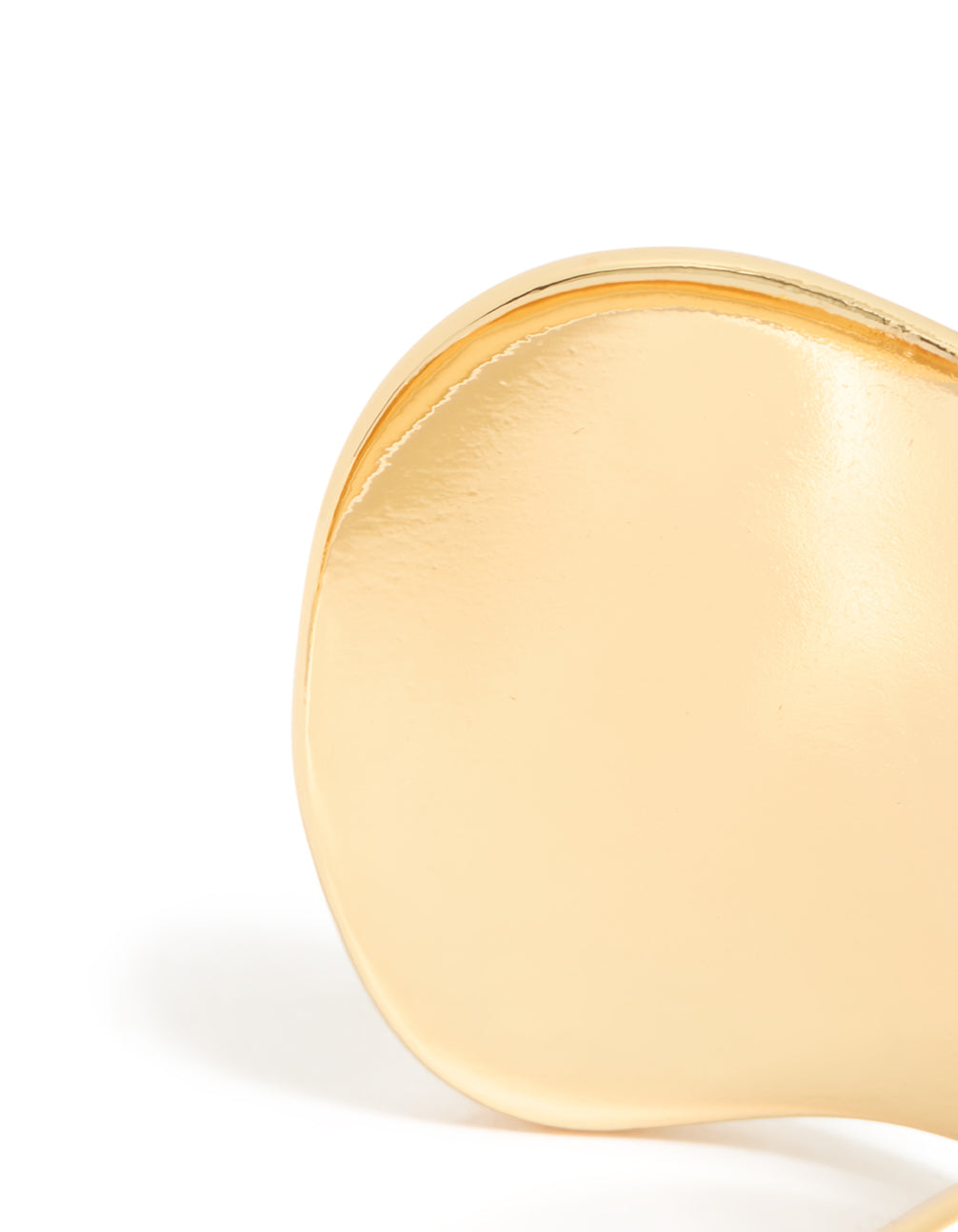 Showcasing a gold plated wide organic wrist cuff in statement bangle style close up view