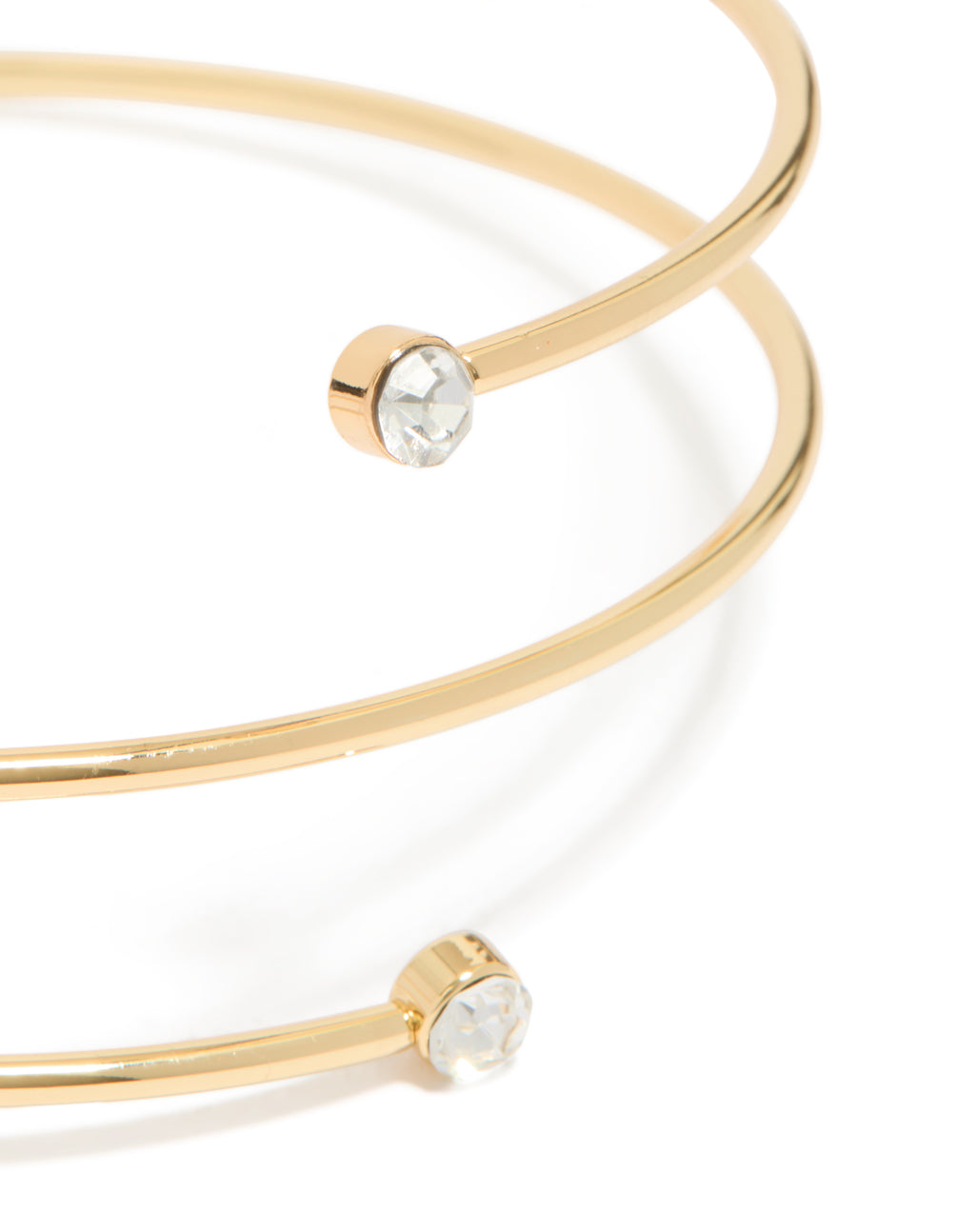Showcasing a gold plated diamante wrap around arm cuff with statement design close up view