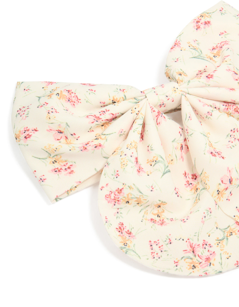 Printed fabric bow clip with floral pattern featuring leaf details in ivory, light pink, peachpuff, and pale green side view