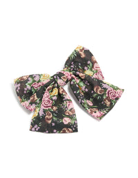 Showcasing a large bow clip with printed flowers in black, pink, green, statement style front view - link has visual effect only
