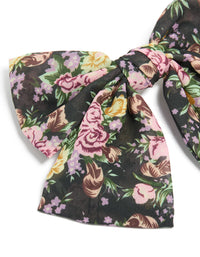 Highlighting a large bow clip with printed flowers in black, pink and green statement style detail view - link has visual effect only