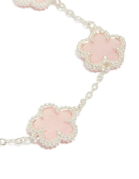 Designed with silver plated finish is this pink flower charms station bracelet featuring floral pattern in dainty style close up view - link has visual effect only