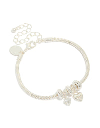 Showcasing a dainty silver plated charm bracelet featuring bow and heart details with cubic zirconia accents front view - link has visual effect only