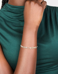 Designed with floral charms, this silver plated oval cubic zirconia toggle bracelet is shown in pink and clear on wrist view - link has visual effect only