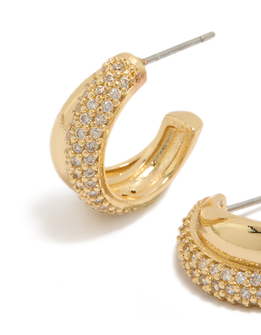 Highlighting gold plated cubic zirconia pavé and plain layered hoop earrings with crystal stones close up view