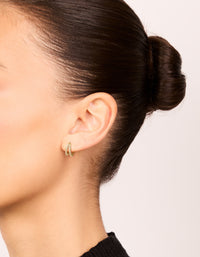 Featuring small double layered earrings with cubic zirconia in huggie closure on ear view - link has visual effect only