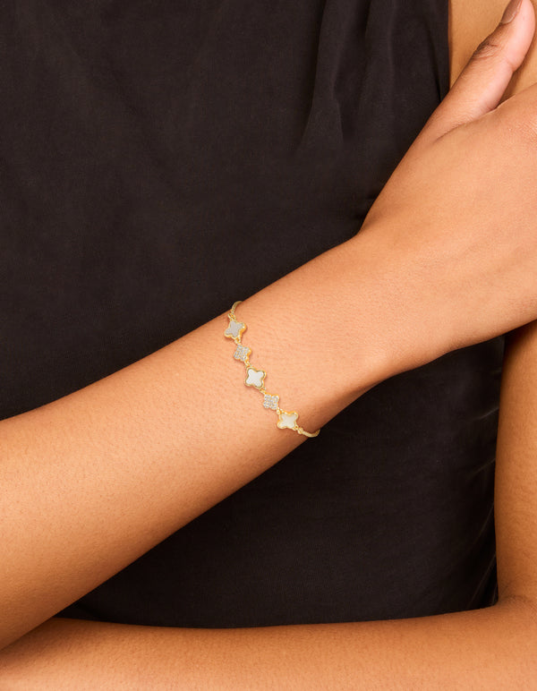 Stunning gold plated cubic zirconia and floral bracelet shown with toggle closure on wrist view