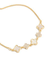 Chic gold plated bracelet featuring cubic zirconia and floral ivory pattern close up view - link has visual effect only