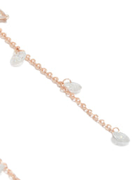 Showcasing rose gold plated cubic zirconia flower station drop earrings with beaded charm details and floral pattern close up view - link has visual effect only