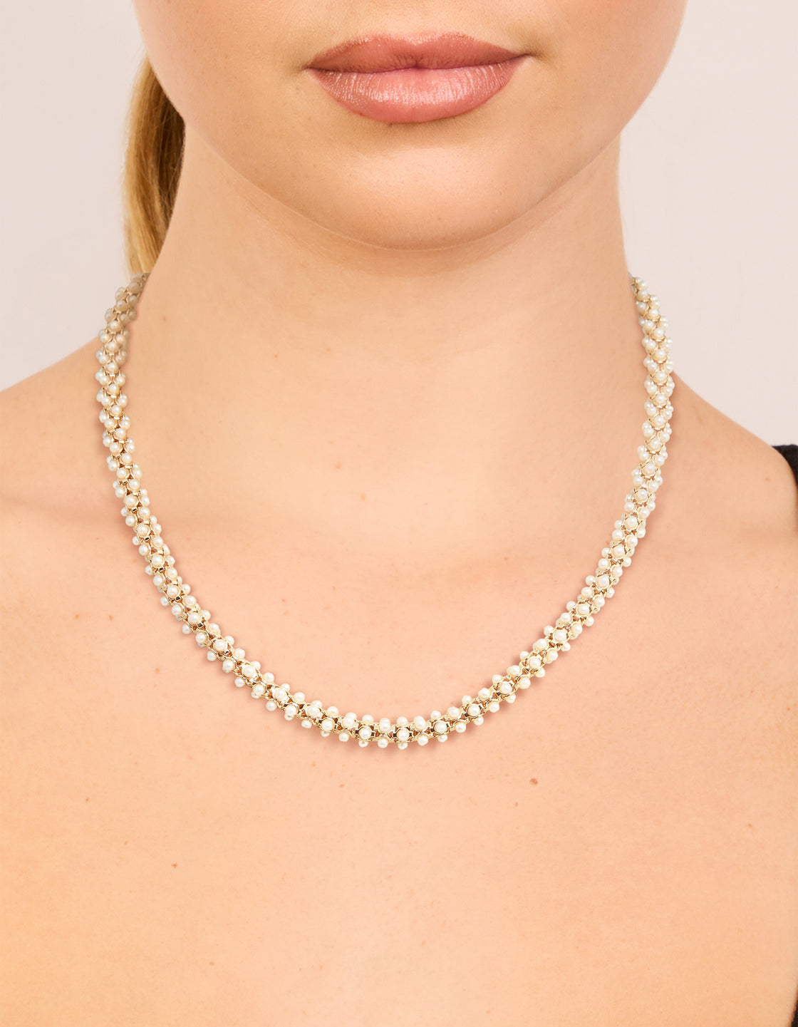 Elegant rose gold plated mini pearls fireball necklace with beads in statement style on neck view