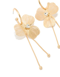Featuring statement style laser cut flower drop earrings in gold close up view - link has visual effect only