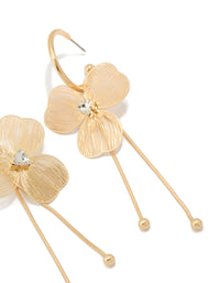 Featuring statement style laser cut flower drop earrings in gold close up view - link has visual effect only