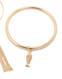Crafted from gold with charm and tassel details, these bangles in a 3-pack feature shell and ocean-inspired accents closure detail view - link has visual effect only