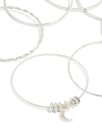 Crafted from silver with celestial charm bangles featuring diamante moon and star accents in a statement 7-pack set close up view - link has visual effect only