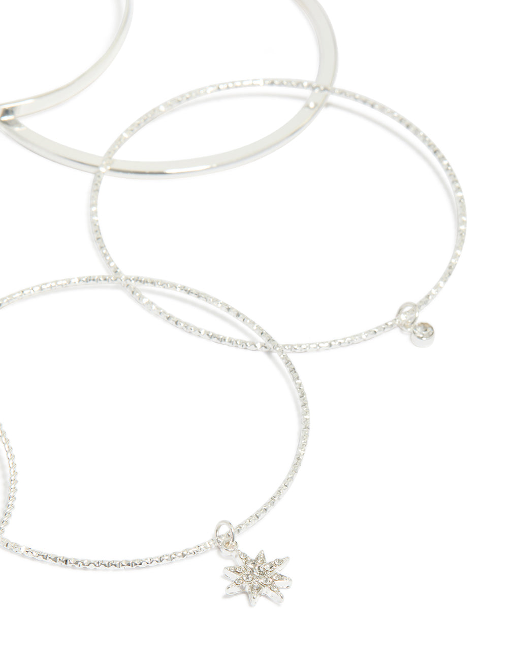 Designed with silver celestial charm bangles featuring diamante moon and star accents in a statement 7-pack set closure detail view