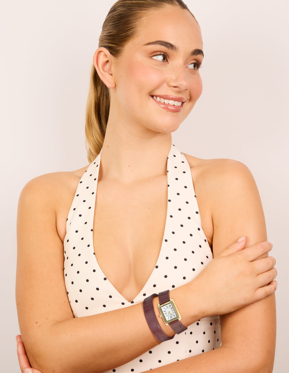 Showcasing a women's analog watch with white roman rectangle dial, brown leather strap, and gold PU material for formal wear on model  view