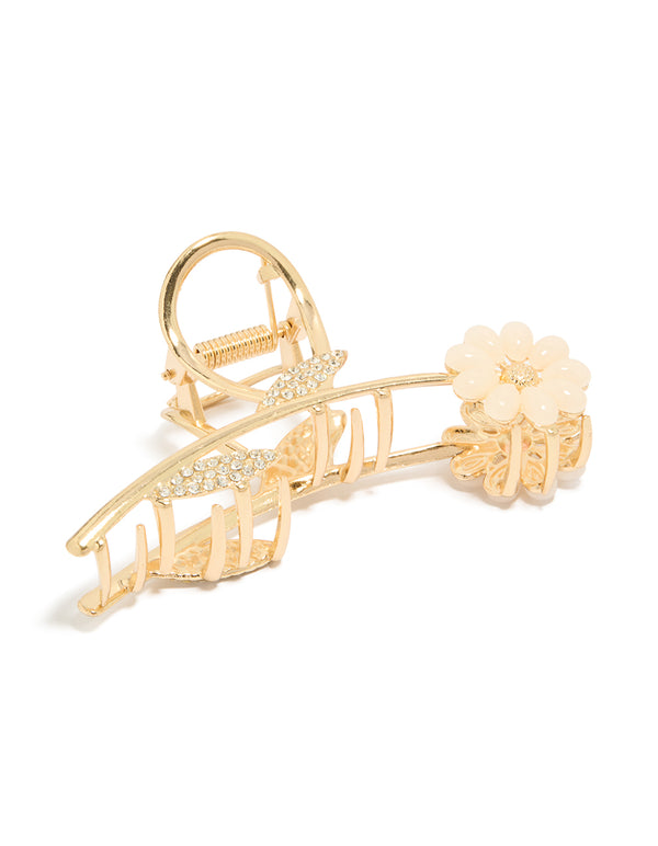 Showcasing a floral resin claw clip with leaf accents featuring diamante embellishments in pink and white on gold side view