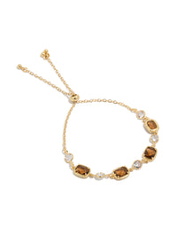 Showcasing a gold plated clear and cognac cubic zirconia square cut bezel toggle bracelet front view - link has visual effect only