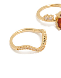 Detailed look at wavy band gold plated rings with cubic zirconia stones in teardrop shape and crystal embellishments 3-pack close up view - link has visual effect only