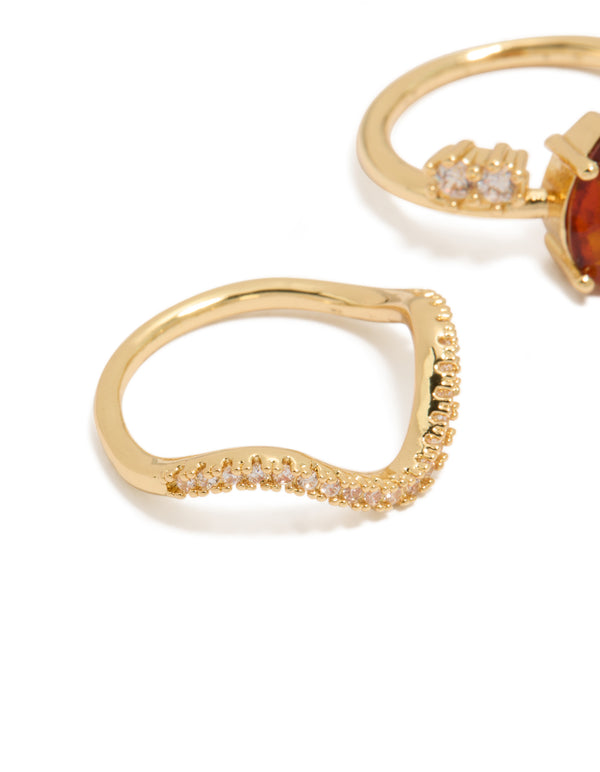 Detailed look at wavy band gold plated rings with cubic zirconia stones in teardrop shape and crystal embellishments 3-pack close up view