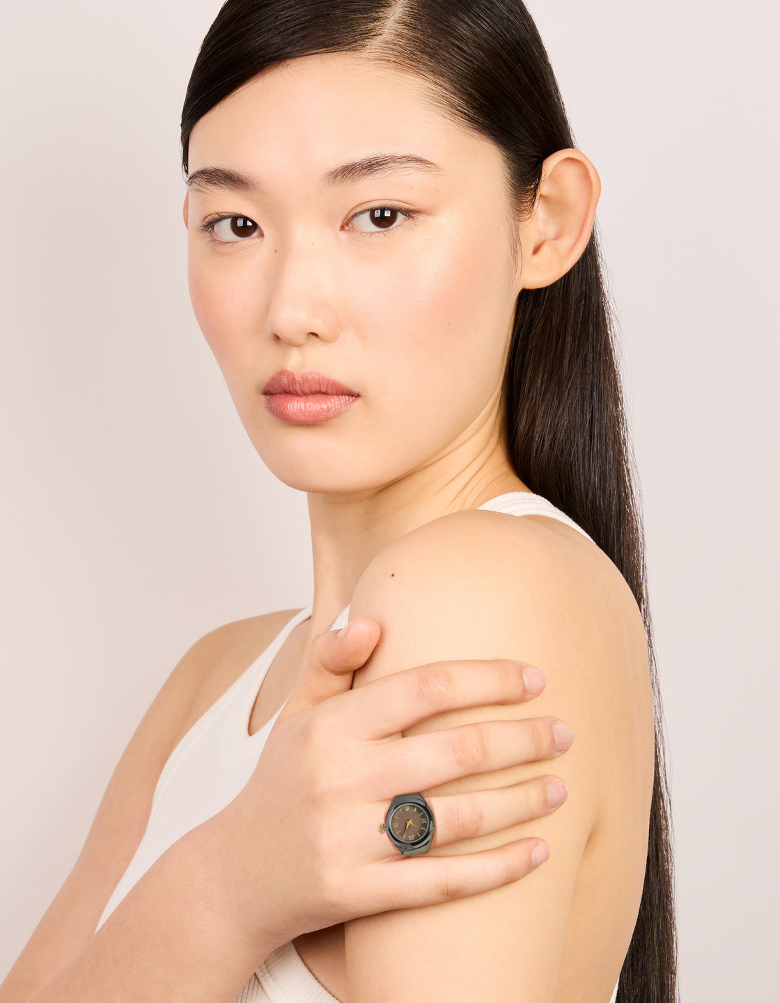 Displaying a statement watch ring in gold and black on finger view