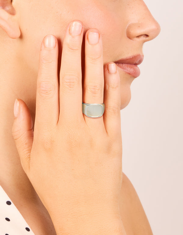 Crafted from waterproof stainless steel, this square signet ring with shell in silver and clear on finger view