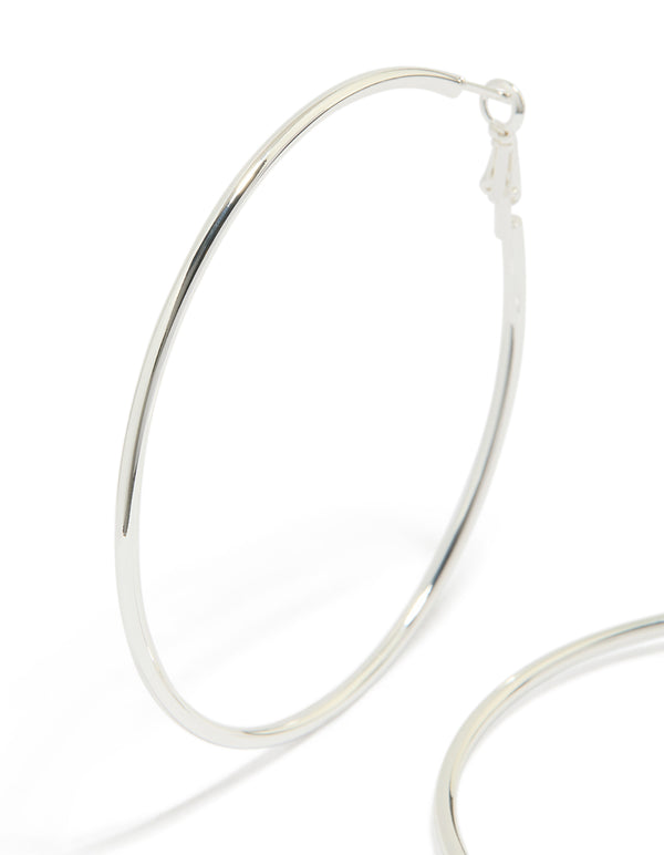 Featuring statement thin hoop earrings in waterproof stainless steel with silver finish 65 MM close up view
