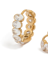 Explore waterproof huggie earrings crafted from gold plated stainless steel featuring round bezel set cubic zirconias in clear close up view - link has visual effect only