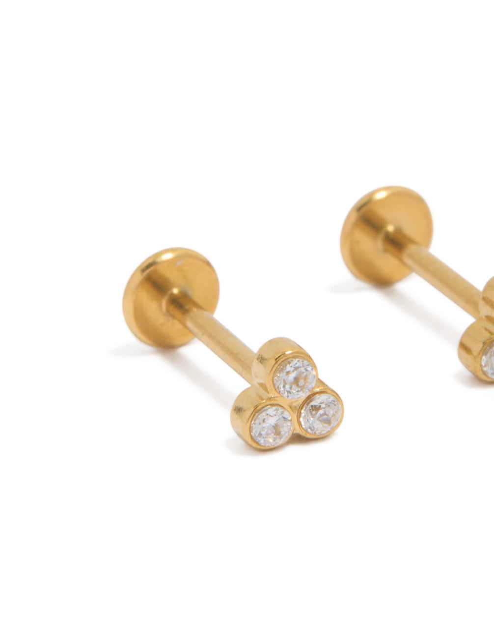 Detailed view of waterproof trio bezel set cubic zirconia flat back studs in gold plated stainless steel close up view