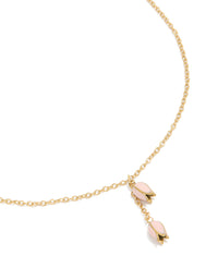 Showcasing a charm floral necklace crafted from waterproof stainless steel with gold plated finish in pink, dainty close up view - link has visual effect only