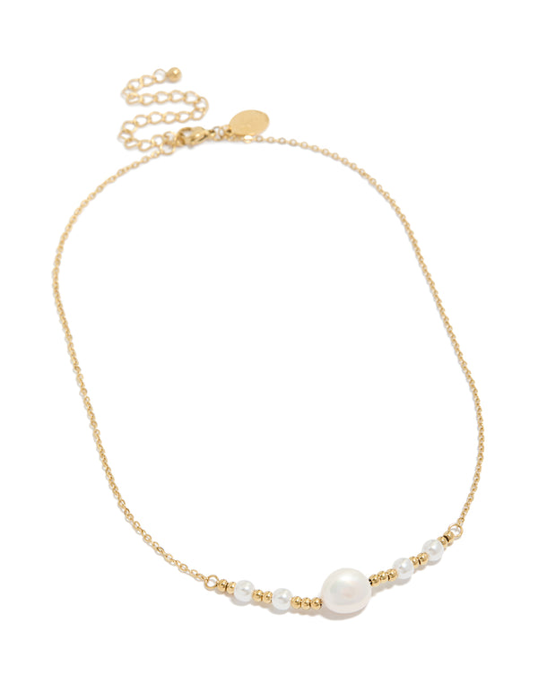 Introducing a waterproof statement necklace crafted from stainless steel featuring beads and pearl accents in gold plated and white tones front view