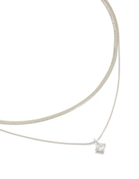 Showcasing a waterproof layered necklace featuring snake chain, round cubic zirconia, crystal accents, and stainless steel in silver close up view - link has visual effect only