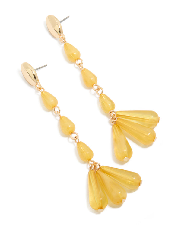 Showcasing statement drop earrings featuring beaded design in gold and orange front view