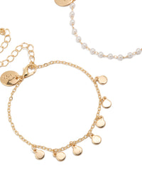 Detailed view of gold discs and pearl 2-pack bracelets close up view - link has visual effect only