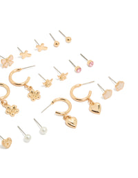 Explore this dainty stud earrings 12-pack featuring bow charm cross floral, balls and heart designs enamel crafted in gold with pearl accents white and pink details close up view - link has visual effect only