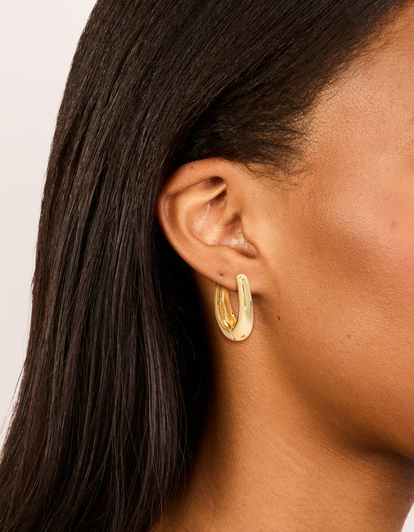 Showcasing gold plated skinny teardrop hoop earrings with closure on ear view