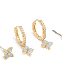 Featuring gold plated blue flower stud and huggie earrings in a 3-pack with balls in powder blue accents close up view - link has visual effect only
