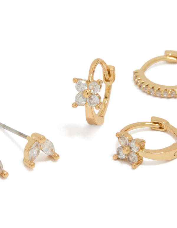 Showcasing mini flower dainty huggie and stud earrings in a 3-pack with gold plated cubic zirconia detailing close up view