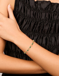 Elegant gold plated alternating round green cubic zirconia link bracelet on wrist view - link has visual effect only