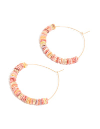 Showcasing large hoop earrings with beaded genuine pink shells and statement style in gold front view - link has visual effect only