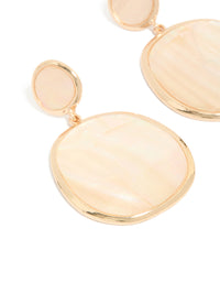 Crafted from shell, these statement drop earrings showcase pink and gold tones with ocean elements close up view - link has visual effect only