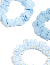 Featuring daisy flower and checkered fabric scrunchies in a 5-pack with light blue, ivory, white detail view - link has visual effect only