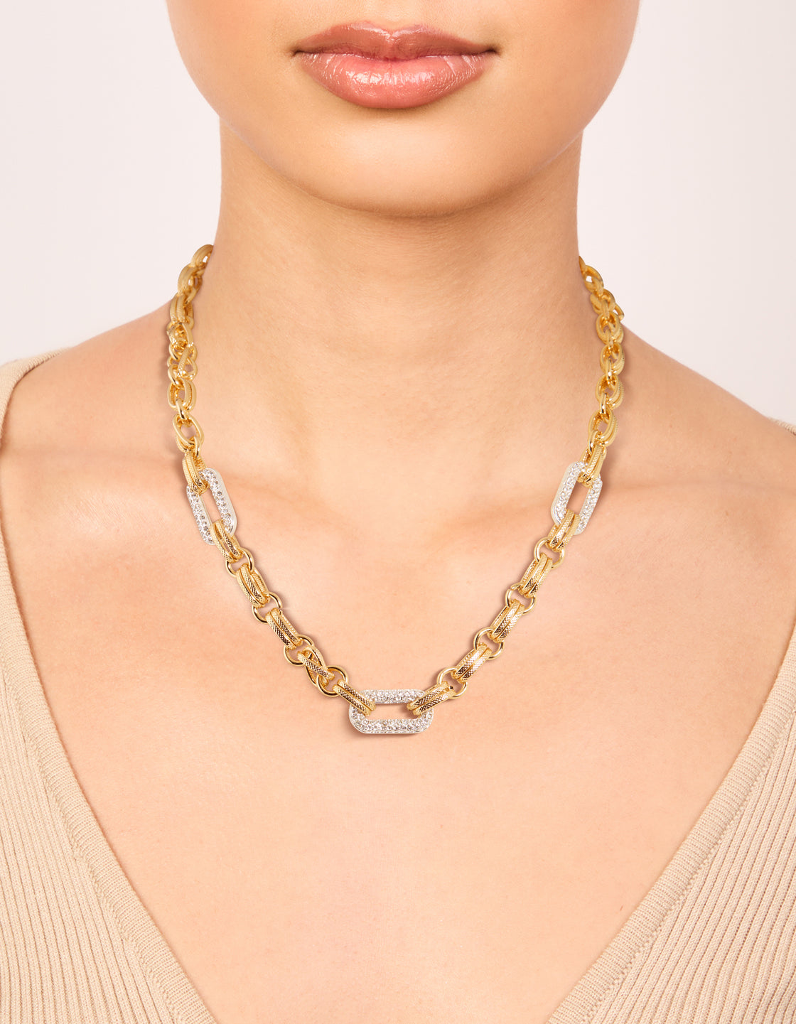 Featuring a mixed metal plated diamante large multi link necklace with gold and silver in statement style on neck view