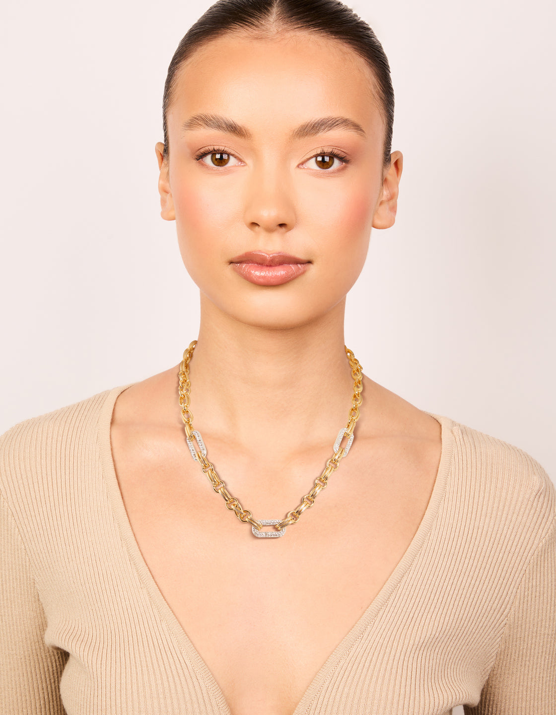 Presenting a mixed metal plated diamante large multi link necklace in gold and silver with statement design on model view