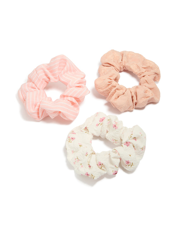 Featuring pink and white mixed floral fabric scrunchies in a 3-pack front view
