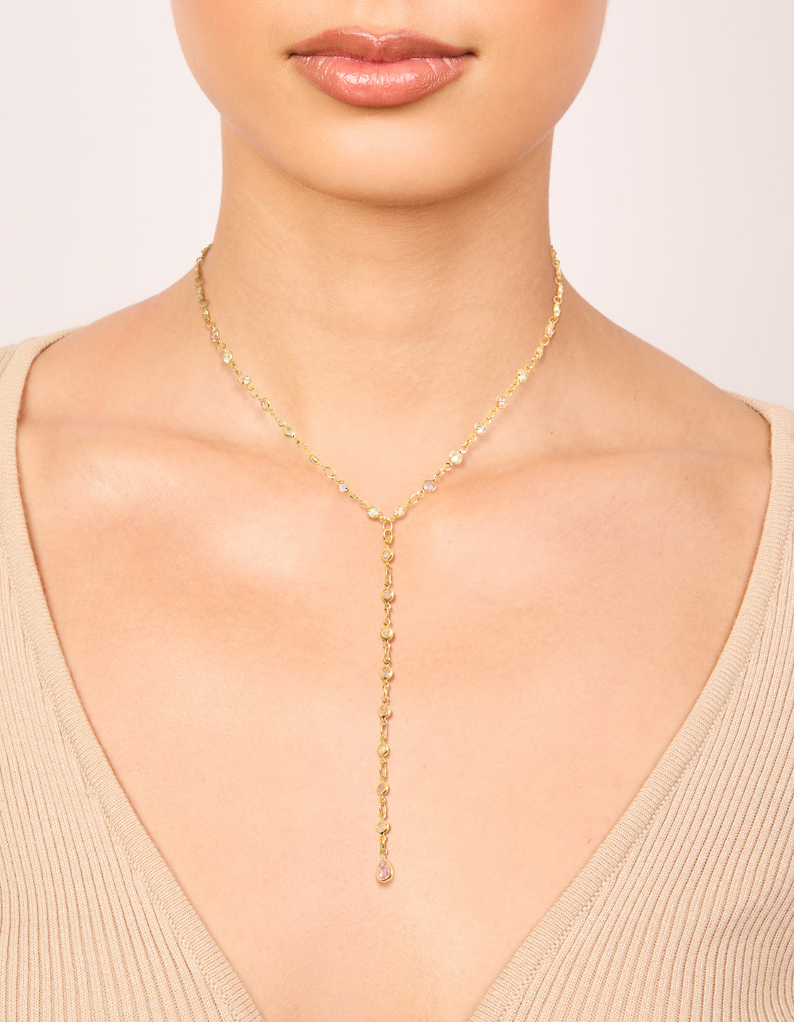 Featuring a gold plated pink and clear cubic zirconia circles Y-necklace with statement dainty styling on neck view